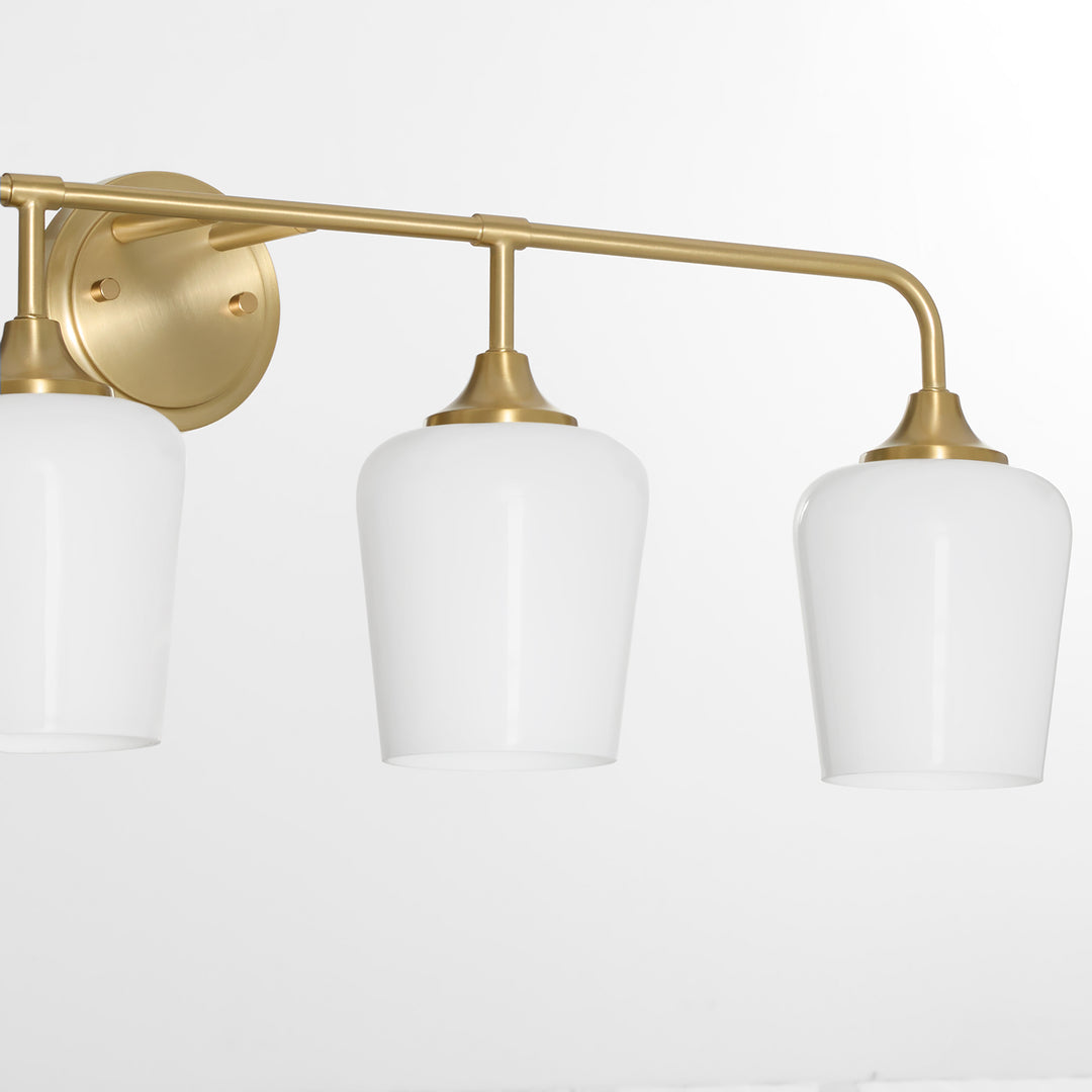 Raymond 4 Light Opal Wall Mount - Aged Brass